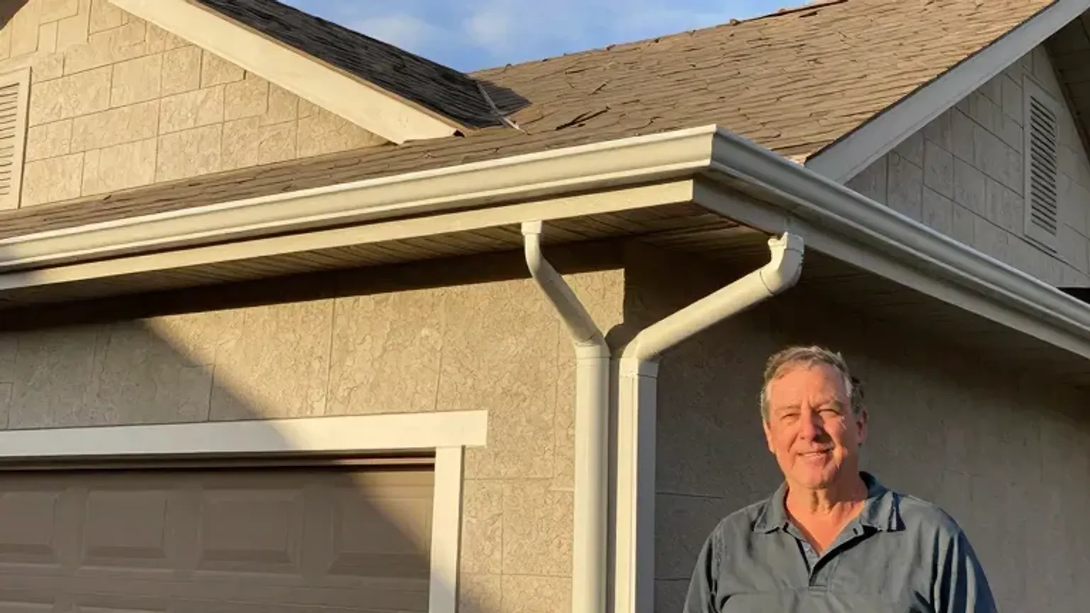 Documentary-style iPhone photo of completed gutter repair with clean roof edge and properly aligned downspouts on a Saratoga Springs, Utah home. Natural afternoon light.