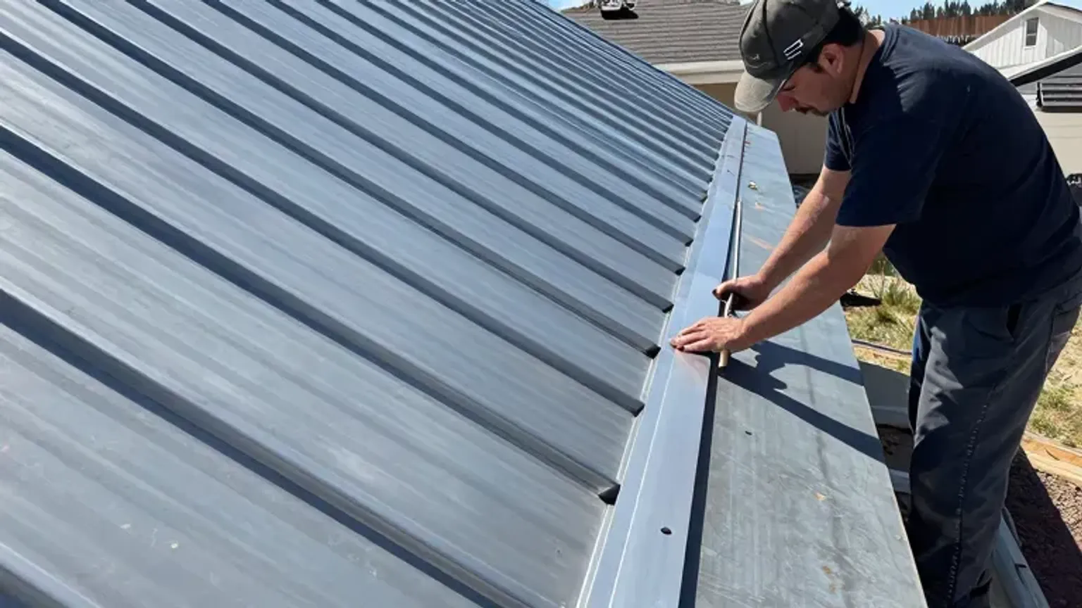 Documentary-style iPhone photo of residential metal roof installation detail in Saratoga Springs, Utah. Natural daylight.